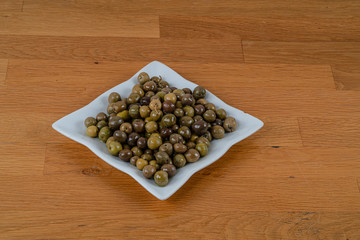 Olives assortment in bowl with oil. 