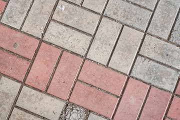 Background image of texture of pedestrian footpath covered by paving tiles