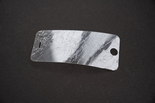 broken smartphone safety glass in black background