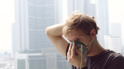 Coronavirus Epidemic - Man Putting on Respirator Mask To Protect Against Illnes