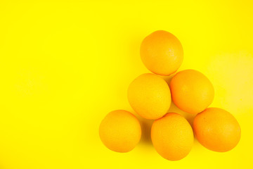 Juicy orange oranges isolated on yellow background