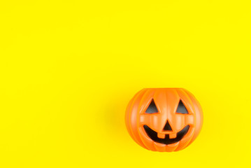 Jack O' Lantern Halloween pumpkin isolated on yellow background