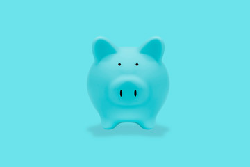 Blue piggy bank on blue background, with clipping path.