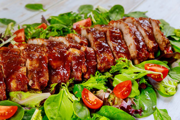 Baked spare baby back ribs with green salad.