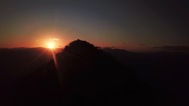 Cinematic sunset drone footage of sunrise over Australian mountain landscape. 