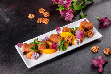 Fresh scented cheese sticks with baked apple and peach decorated with flowers