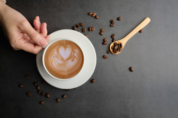 woman hand hold the latte art coffee flat lay . fresh morning lifestyle.