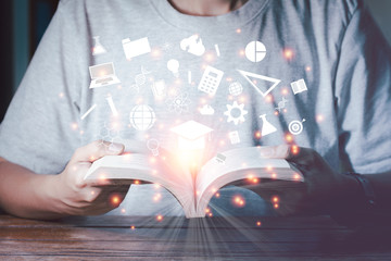 E-learning concept. Man open book with white knowledge icons on vintage tone.