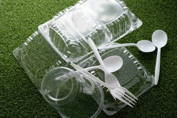 plastic food package on green grass background to recycle and reuse.the environment concern of...