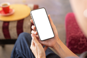 cell phone Mockup image blank white screen.woman hand holding texting using mobile on desk at coffee shop.background empty space for advertise text.people contact marketing business,technology