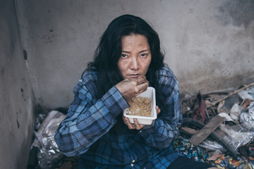 poor people,homeless or beggar begging for help sitting at dirty slum.concept for poverty...