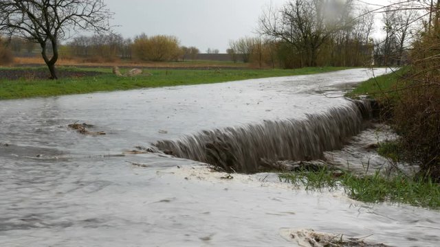 A huge landslide with a flowing dirty big puddle. Natural disaster.