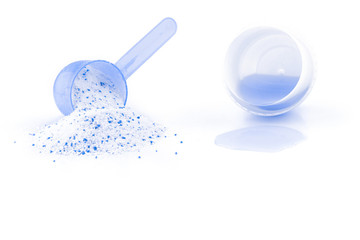 Clean detergent. Wash powder texture in cup or scoop for washing machine isolated on white. Liquid...