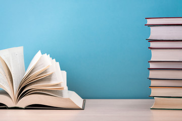 The book is open, lying on the table, the sheets spread out like a fan on a blue background.