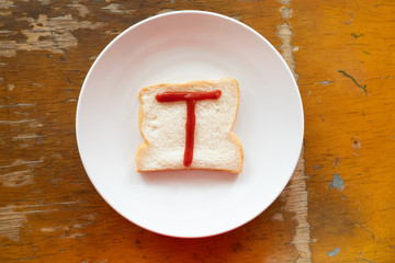 bread of breakfast is written T by ketchup on write plate. A to Z and Number and Special characters set.