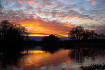 Obraz premium Colorful multicolor sunset over the river 