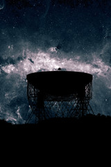 Radio telescope dish silhouette at night with the centre of the  Milky Way stars in the background....