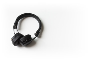 Black headphone on white background. flat lay.