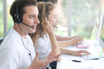 Business people of call center employees are working in office which using headphone to talking with customer, operator consulting