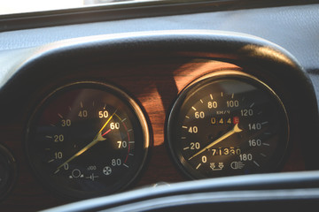 Closeup on a dashboard of a vintage car in sunset light
