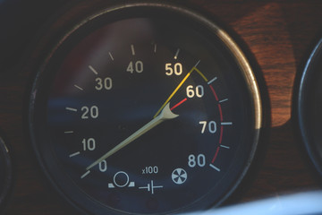 Fototapeta premium Closeup on a tachometer of a vintage car in sunset light
