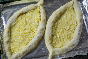 The process of preparing the Caucasian delicacy khachapuri.