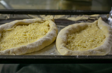 The process of preparing the Caucasian delicacy khachapuri.