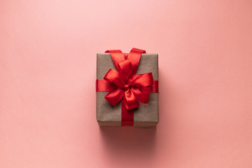 White gift box with red ribbon, black background flat lay for stock image