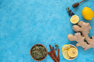 Ingredients for Ginger Tea. Ginger, honey, lemon. Space for text on a blue background.