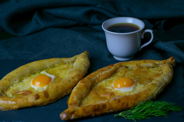 Traditional Georgian food on a black stone with tea.