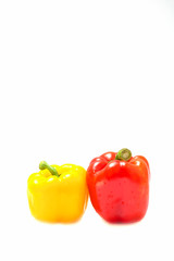 Two yellow and red bell peppers