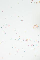 Colourful Sugar sprinkles, decoration for cake, ice-cream and cookies. Top view, Flat lay on white background. Copy space.