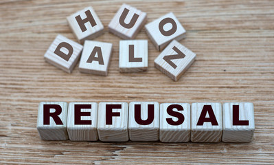 Fototapeta premium concept of the word REFUSAL on cubes on a light wooden background