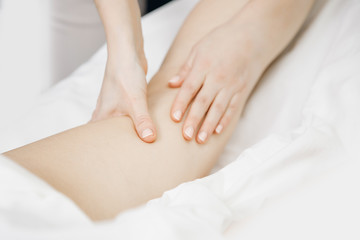Fototapeta na wymiar Anti-cellulite massage treatment on legs of young women beauty spa
