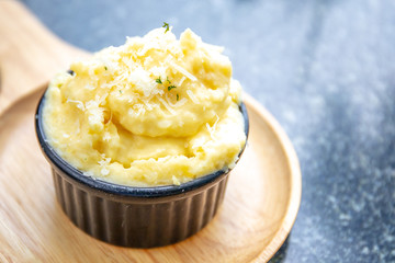 Closeup to Mashed potato in black bowl. with copy space.