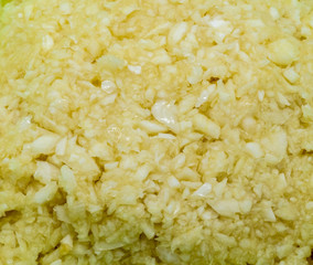 Close up on fresh chopped garlic for texture.
