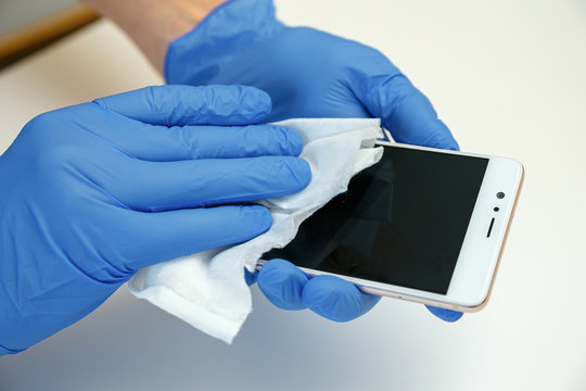 Smartphone Wipe Disinfectants. Covid-19 sanitizing office space wiping corona virus cleaning and disinfection of your workspace.