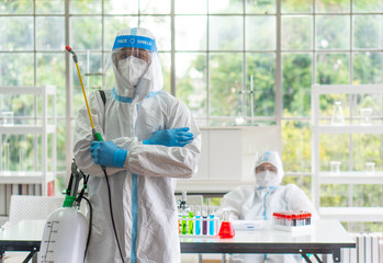 worker from decontamination services wearing personal protective equipment or ppe including suit,...