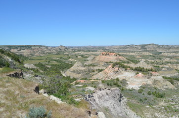 Fototapeta na wymiar Late Spring in the North Dakota Badlands: Looking Northward From the Rim of Painted Canyon with Buck Hill in the Distance in the South Unit of Theodore Roosevelt National Park