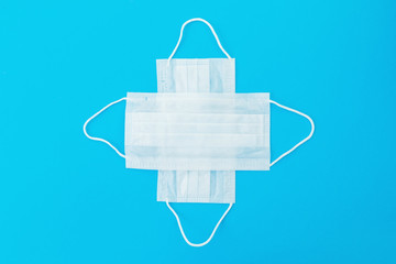 Medical masks for protection from virus and bacteria on a blue background. Flat lay. Epidemic concept.