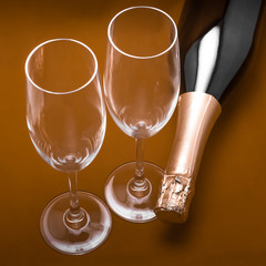 two champagne glasses and bottle, the bottle lies
