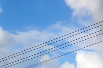 wires against the blue sky and clouds
