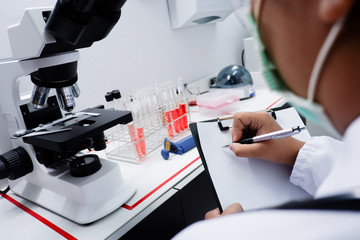 Cropped shot view of  the equipment and science experiments in Laboratory, Chemical substances for research and analyzing a sample under the microscope in laboratory.   