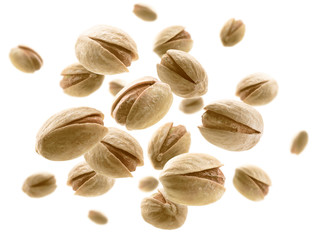 Salted pistachios levitate on a white background