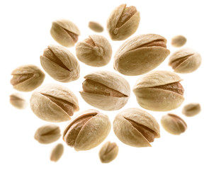 Salted pistachios levitate on a white background