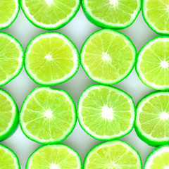 Fototapeta na wymiar Green background with citrus-fruit of lime slices on white background, Lemon texture 
