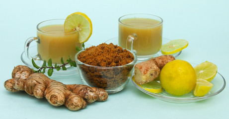 Ginger juice with lemon and brown sugar in a cup and saucer