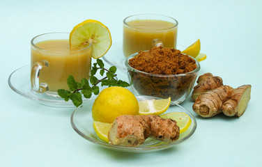 Ginger juice with lemon and brown sugar in a cup and saucer