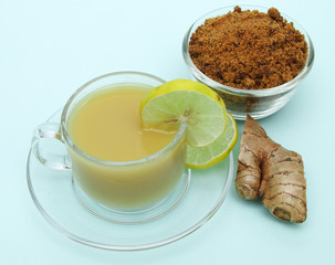 Ginger juice with lemon and brown sugar in a cup and saucer