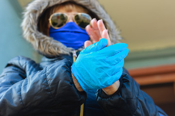 Elderly woman in gloves isolation and disinfection